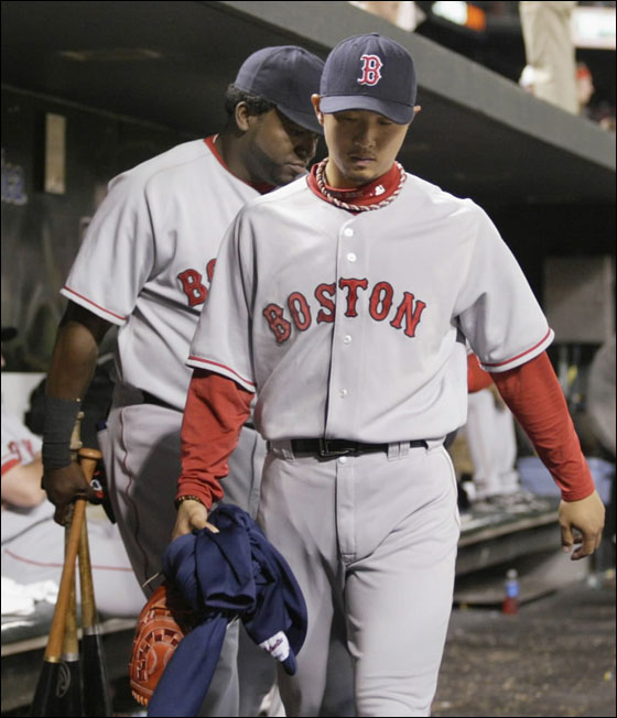 Red Sox relief pitcher Hideki Okajima (R) and designated hitter David Ortiz leave the dugout after losing to the Baltimore Orioles in their MLB American League baseball game in Baltimore, Maryland August 10, 2007. Okajimi was the losing pitcher in the game.