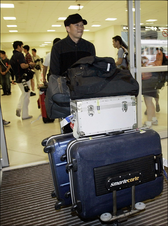 Boston Red Sox pitcher Hideki Okajima carries his luggage after he arrived at Southwest Florida International Airport in Fort Myers, Fla, Wednesday, Feb., 14, 2007 to attend baseball spring training camp.