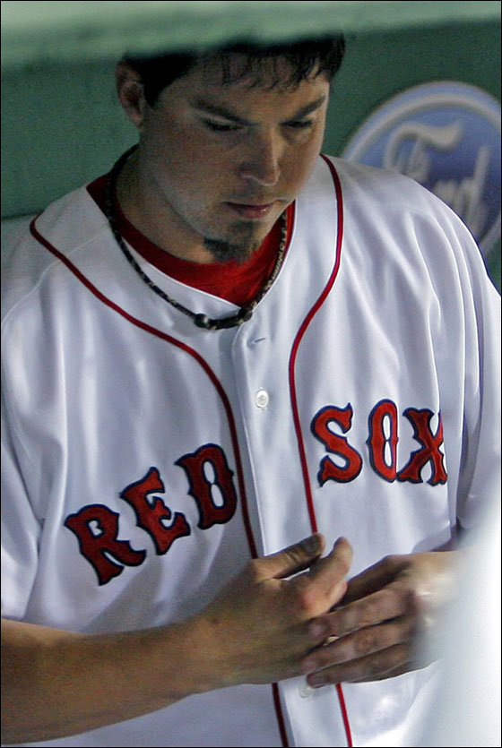 Josh Beckett feels his finger in the dugout after finishing his night's work after the seventh inning.