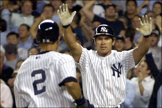 New York Yankees Johnny Damon, center, greets Derek Jeter at home plate as Detroit Tigers catcher Ivan Rodriguez watches during the sixth inning in Game 1 of Major League Baseball's American League Division Series Tuesday, Oct. 3, 2006 at Yankee Stadium in New York. Damon and Jeter scored on a base hit by Bobby Abreu.