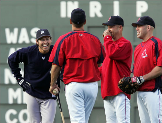 Current New York Yankees outfielder and former Boston Red Sox player, Johnny Damon, left, laughs while talking to Boston Red Sox coach Bill Haselman, second left, manager Terry Francona, and infielder Kevin Youkilis, right, prior to their baseball game at Fenway Park in Boston Monday, May 22, 2006