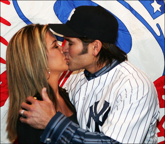 Johnny Damon of the New York Yankees kisses his wife Michelle after being introduced as the new center fielder on December 23, 2005 at Yankee Stadium in the Bronx Borough of New York City.