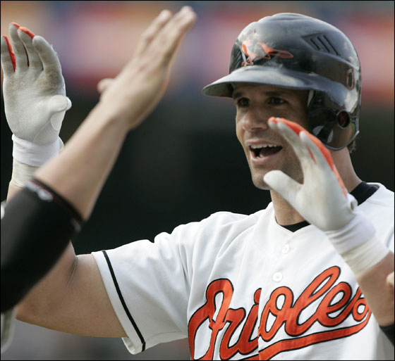 Baltimore Orioles' Javy Lopez gets high-fives from teammates after driving in the game-winning run during the ninth inning against the Chicago White Sox during their baseball game Sunday, July 30, 2006, in Baltimore.