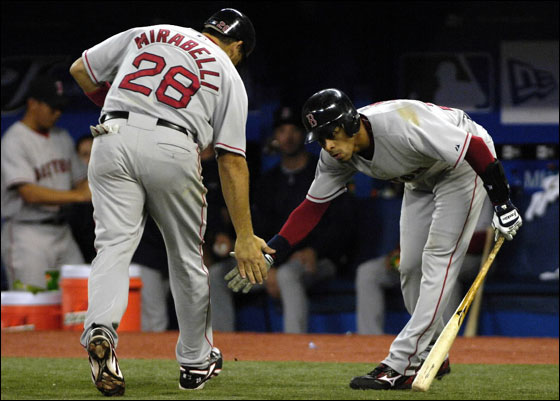 Boston Red Sox's Julio Lugo, right, celebrates with teammate Doug Mirabelli after scoring on his solo home run against the Toronto Blue Jays during sixth inning baseball action in Toronto, Wednesday, April 18, 2007.