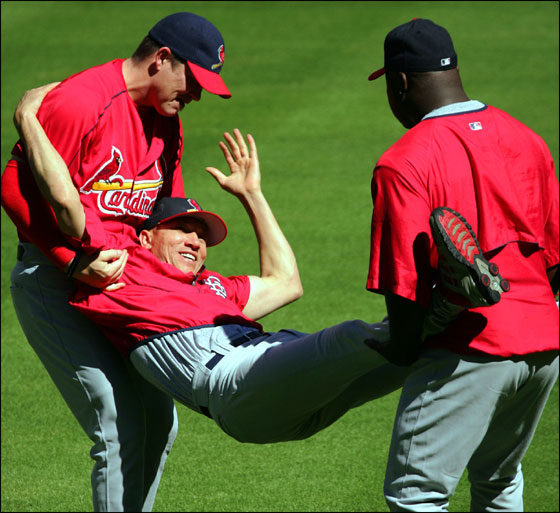 St. Louis Cardinals pitchers Jason Isringhausen, left, and Ray King, right, play a little rough house by carrying  fellow pitcher Julian Tavarez in the infield during a team workout in Houston, Friday, Oct. 15, 2004. The Cardinals, leading the best-of-seven games National League Championship Series 2-0, play the Houston Astros in Game 3 on Saturday, Oct. 16.