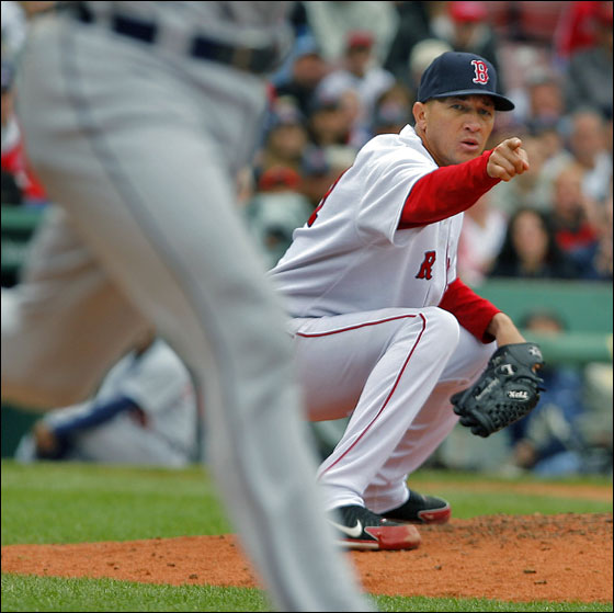 Red Sox starting pitcher Julian Tavarez points the way, as he throw to first to double up the Tigers Ivan Rodriguez (left) reaches its destination. The double play ended the top of the fourth inning.