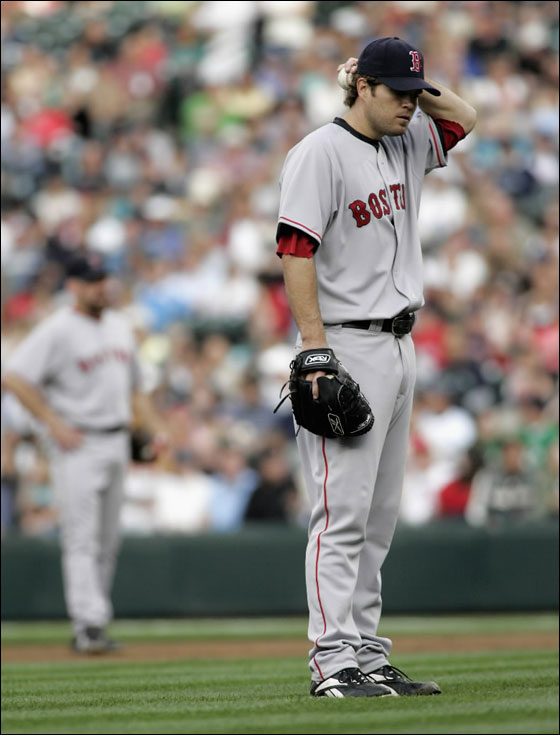 Red Sox starting pitcher Kason Gabbard steps off the mound after walking in a run during the first inning of their American League MLB baseball game against the Seattle Mariners in Seattle
