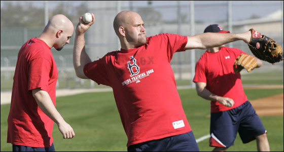 Red Sox infielder Kevin Youkilis threw during informal workouts in Fort Myers today. At left is non-roster invitee, outfielder Dustan Mohr.