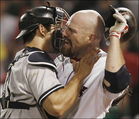 New York Yankees catcher Jorge Posada, left, holds back Boston Red Sox's Kevin Youkilis after Yankees pitcher Scott Proctor (not shown) hit Youkilis with a pitch in the ninth during their baseball game at Fenway Park in Boston, Friday, June 1, 2007. 