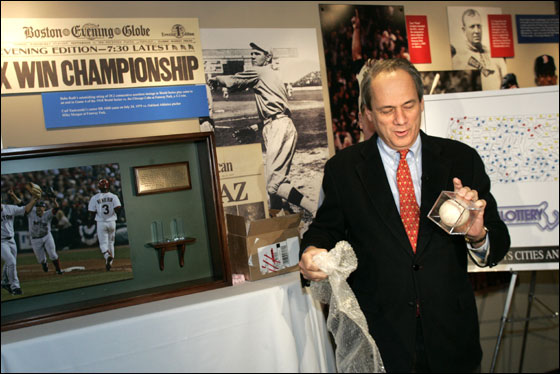 President/CEO of the Boston Red Sox Larry Lucchino unwraps the final out World Series ball at Fenway Park after it arrived by Brinks truck to the park.