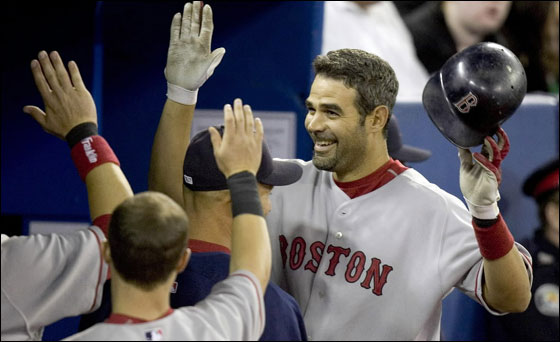 Boston Red Sox third baseman Mike Lowell is congratulated by team mates after hitting a home run in the fifth inning off Toronto Blue Jays starting pitcher Tomo Ohka at their baseball game in the Rogers Centre in Toronto April 18, 2007.