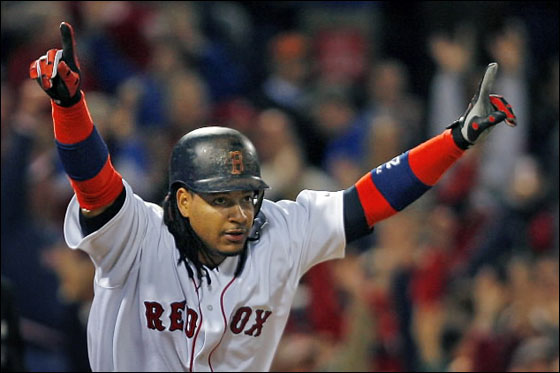 Manny Ramirez won a wild one for the Red Sox tonight with a bottom of the eighth inning solo home run, his second round tripper of the night, as Boston defeated the Mariners 8-7 at Fenway Park. Here he raises his arms in triumph as the crowd goes wild in the backround as the ball sails out of the park.