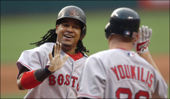 Red Sox Manny Ramirez receives congratulations from Kevin Youkilis after hitting a home run off Cleveland Indians starting pitcher Cliff Lee in the second inning of their MLB American League baseball game in Cleveland, Ohio July 26, 2007.