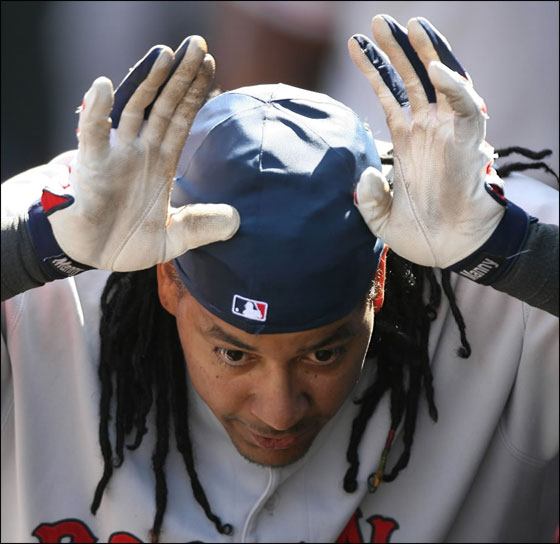 Manny Ramirez #24 of the Boston Red Sox celebrates in the dugout by imitating a charging bull after hitting a solo homer in the fifth inning against the Seattle Mariners on August 5, 2007 at Safeco Field in Seattle, Washington. The Red Sox defeated the Mariners 9-2.