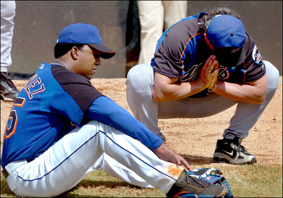 New York Mets pitcher Pedro Martinez, left, takes a break fom a bullpen session and talks about his progress with pitching coach Rick Peterson during a short baseball workout for Martinez Saturday, March 11, 2006 in Port St. Lucie, Fla.