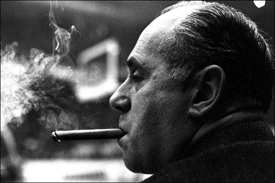 Boston Celtics coach Red Auerbach sits on the bench at Boston Garden smoking a cigar after the Celtics took a commanding lead against the Los Angeles Lakers, securing Auerbach's 1000th NBA victory in Boston, in this Jan. 13, 1966 photo.