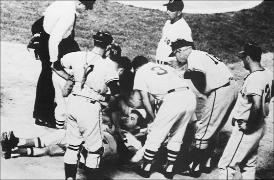 Red Sox player Tony Conigliaro is surrounded by teammates after being hit on the head by a fourth-inning fast ball from Jack Hamilton of the California Angels. Boston, August 18, 1967