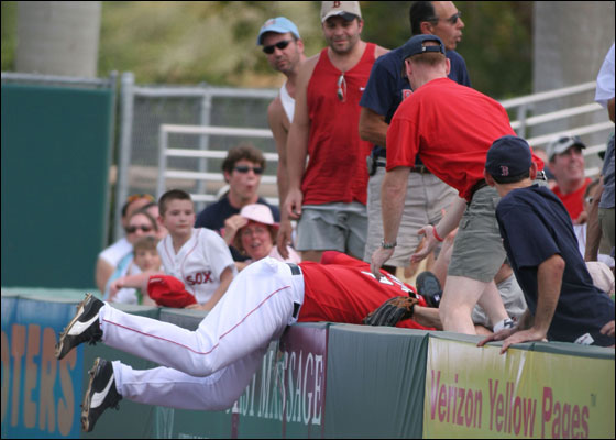 Trot Nixon of the Boston Red Sox falls into the stands as he makes the catch during the game against the Los Angeles Dodgers on March 13, 2006 at City of Palms Park in Fort Myers, Florida.