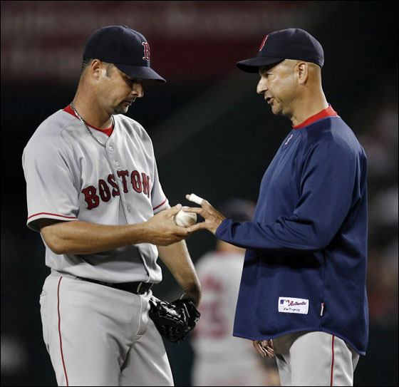 Boston Red Sox pitcher Tim Wakefield  hands over the ball to manager Terry Francona after giving up three runs to the Los Angeles Angels during the fifth inning of a MLB American League baseball game in Anaheim, California August 7, 2007.