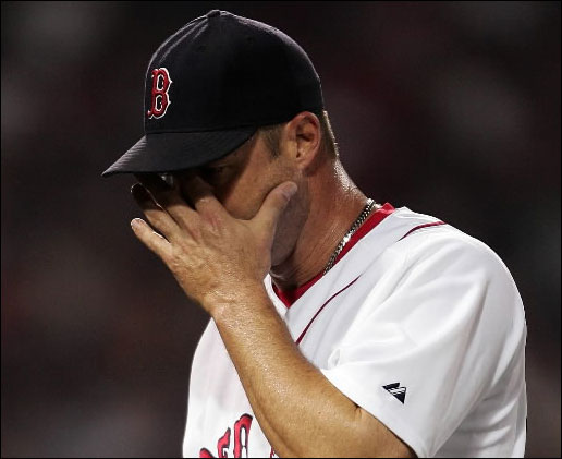 Tim Wakefield #49 of the Boston Red Sox wipes his face as he heads to the dugout after he was pulled out in the fourth inning against the New York Yankees at Fenway Park June 1, 2007 