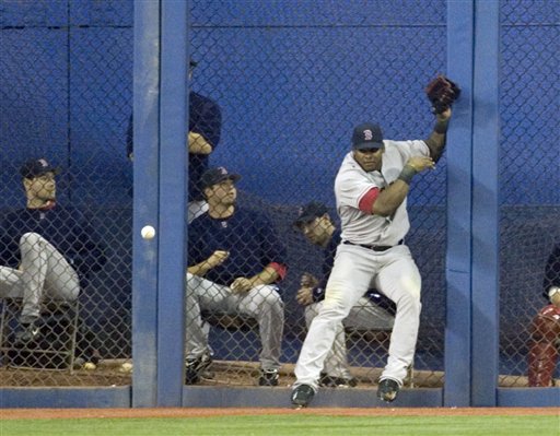 Red Sox right fielder Wily Mo Pena can't handle the ball at the fence on a hit from Toronto Blue Jays' Alex Rios the sixth inning during AL baseball action in Toronto, Sunday, Sept. 24, 2006. The Blue Jays scored two runs on the play, and took the game 13-4.(