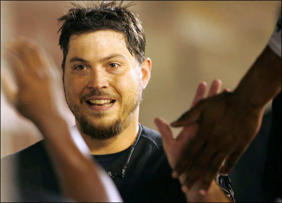 Starting pitcher Josh Beckett, No. 21 of the Florida Marlins, is congratulated in the dugout after hitting a home run during the 5th inning of the game against the Washington Nationals on September 8, 2005 at RFK Stadium in Washington, DC.