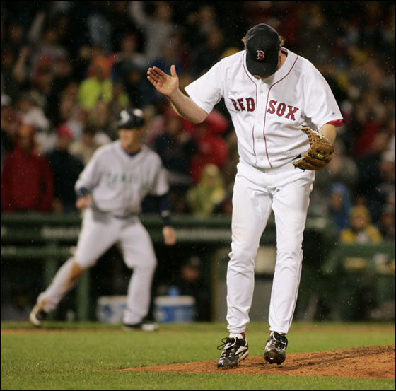 Curt Schilling reacts after striking out Jose Lopez to end the sixth, stranding Seattle's Jeremy Reed (background) at third; Schilling, who allowed three hits and fanned seven, improved to 3-0.
