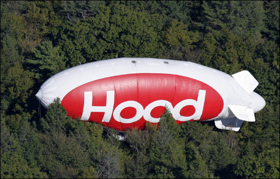 A Hood blimp crashed into a wooded area Tuesday when the pilot lost rudder control shortly after takeoff and tried to make an emergency landing on a nearby beach, authorities said.