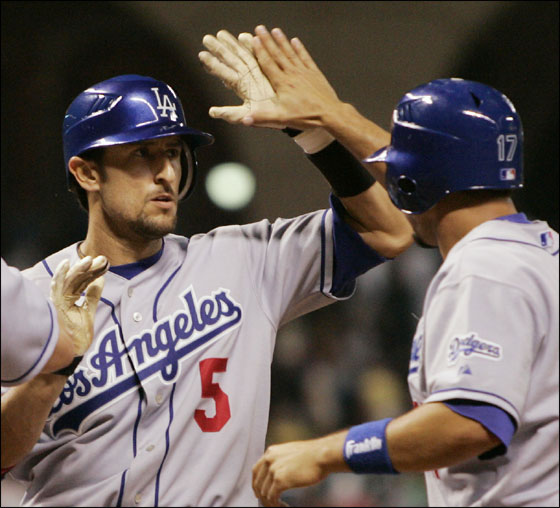 Los Angeles Dodgers' Nomar Garciaparra is congratulated by teammates Jeff Kent, and Jason Repko after hitting a grand slam against the Houston Astros during the ninth inning of their Major League Baseball game Monday, April 24, 2006, in Houston.