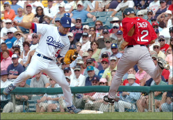 Los Angeles Dodgers first baseman Nomar Garciaparra, left, beats Boston Red Sox base runner Coco Crisp to first base to get the out during a spring training baseball game Thursday March 9, 2006 in Vero Beach, Fla.