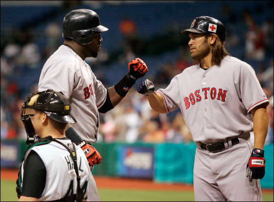 Red Sox's David Ortiz celebrates with teammate Johnny Damon after hitting a two-run homer off of Tampa Bay Devil Rays pitcher Seth McClung during the first inning of their American League game at Tropicana Field in St. Petersburg, Florida