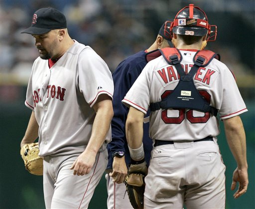 Red Sox pitcher David Wells, left, leaves the mound after being taken out of the game against the Tampa Bay Devil Rays in the third inning Monday night Sept. 19, 2005 in St. Petersburg, Fla. Wells pitched 2 and 2/3 innings, giving up four runs on 10 hits. On the mound is manager Terry Francona and catcher Jason Varitek.