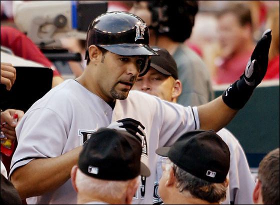 Florida Marlins Mike Lowell is congratulated in the dugout after hitting a two-run home in the second inning against the St. Louis Cardinals at Busch Stadium in St. Louis, Missouri on August 1, 2005