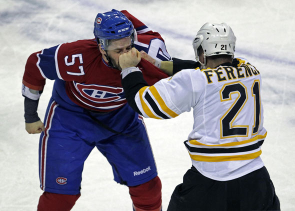 The Bruins Andrew Ference lands a solid left to the face of the Canadiens Benoit Pouliot late in the first period. The Boston Bruins visited the Montreal Canadiens in an NHL Playoff Game held at the Bell Centre.