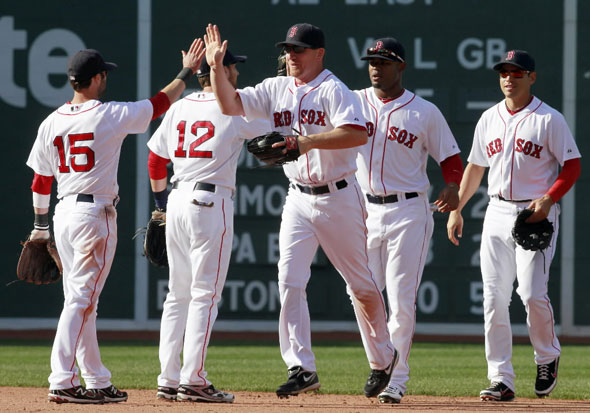 .D. Drew, center, celebrates with teammates, from left, Dustin Pedroia, Jed Lowrie, Carl Crawford and Jacoby Ellsbury after beating the Toronto Blue Jays 8-1 in the ninth inning of a major league baseball game, Sunday, April 17, 2011, in Boston. 