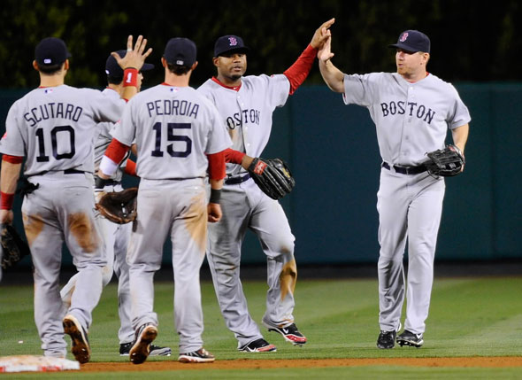 J.D. Drew, Carl Crawford, Dustin Pedroia, Marco Scutaro, and Jacoby Ellsbury of the Boston Red Sox celebrate after defeating the Los Angeles Angels of Anaheim in 11 innings at Angel Stadium of Anaheim on April 21, 2011 in Anaheim, California.