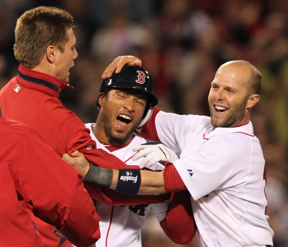 Red Sox Darnell McDonald celebrates with teammates Jonathan Papelbon (left) and Dustin Pedroia after his game winning hit against the Texas Rangers during 9th inning action at Fenway Park on Tuesday April , 20 2010.