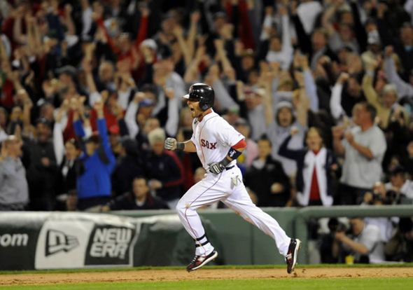 Dustin Pedroia reacts after hitting a two-run home run against the New York Yankees during the seventh inning of the first American League baseball game of MLB's 2010 season at Fenway Park in Boston, Massachusetts April 4, 2010.