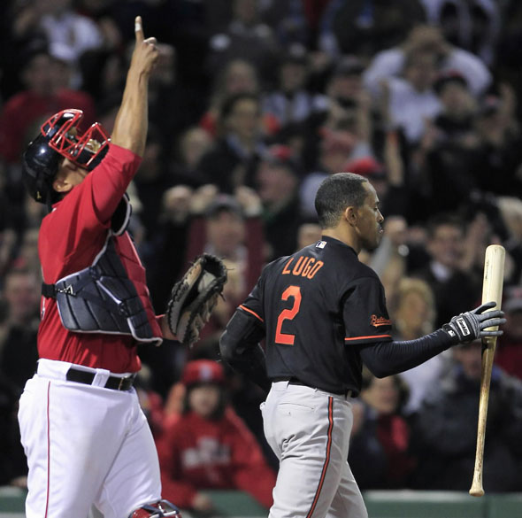 Julio Lugo, right, catches his bat after striking out to end the game as Boston Red Sox catcher Victor Martinez points upward during a baseball game at Fenway Park in Boston, Friday, April 23, 2010.