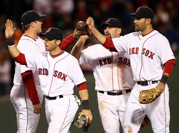 Jonathan Papelbon, Marco Scutaro, Kevin Youkilis and Mike Lowell congratulate each other after they defeated the Baltimore Orioles 7-6 in a baseball game at Fenway Park in Boston, Saturday, April 24, 2010.