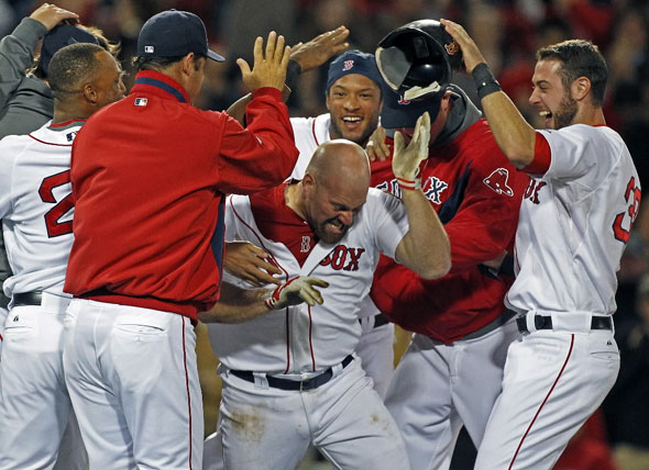  Kevin Youkilis is mobbed by teammates following his 12th inning game winning hit that gave Boston an 8-7 victory over Texas. The Boston  Red  Sox take on the Texas Rangers at Fenway Park