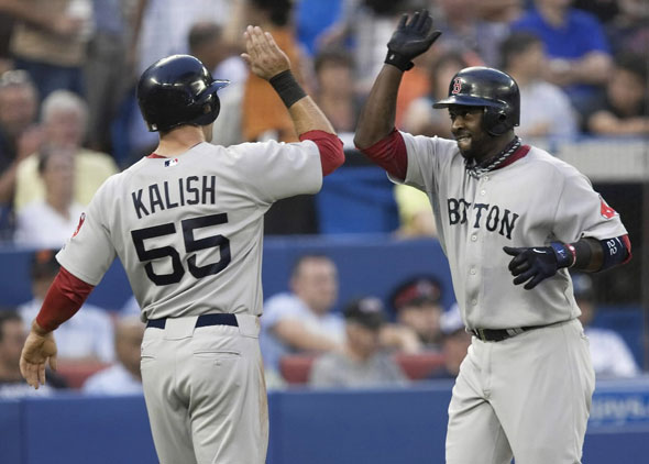 Red Sox second baseman Bill Hall, right, celebrates with Red Sox left fielder Ryan Kalish, left, after hitting a two run homerun against Toronto Blue Jays starting pitch Shaun Marcum during fourth inning of their baseball game in Toronto on Wednesday, Aug. 11, 2010.