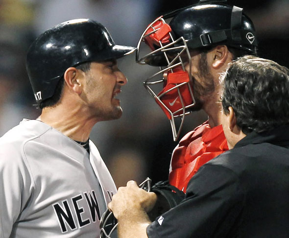 Francisco Cervelli, left, argues with Boston Red Sox catcher Jarrod Saltalamacchia after he was hit by a pitch from John Lackey during the seventh inning of a baseball game at Fenway Park 