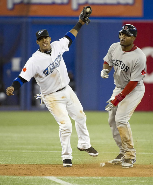 Toronto Blue Jays Yunel Escobar celebrates tagging out Boston Red Sox Carl Crawford on steal attempt during the seventh inning of their American League MLB baseball game in Toronto, May 11, 2011.