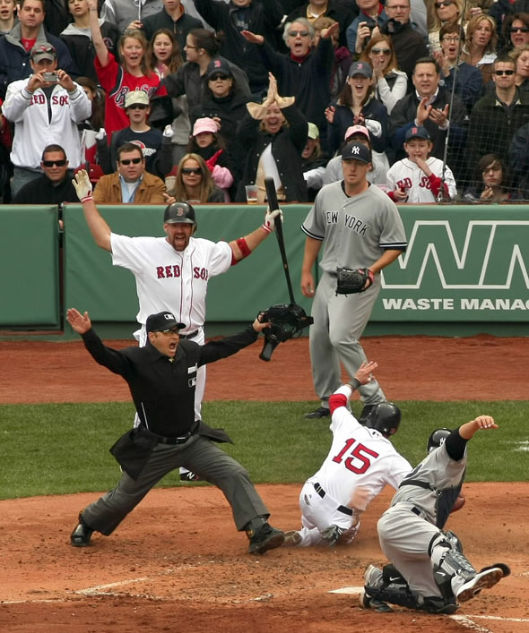 4/8/2011-Red Sox home opener-Sox vs Yankees .. In the 2nd inning, Dustin Pedroia slides in safely at home on a single by Sox Adrian Gonzalez past the tag of Yankees catcher Russell Martin. Umpire Mark Wegner made the call. Sox Kevin Youkillis (left rear) cheers. 