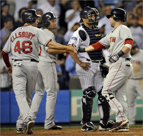 Dustin Pedroia (right) got congratulated by Jacoby Ellsbury and Coco Crisp at home plate after hitting a grand slam in the seventh inning Wednesday night.