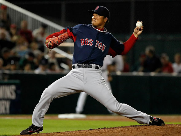 Pitcher Hideki Okajima of the Boston Red Sox pitches against the Minnesota Twins during a Grapefruit League Spring Training Game at Hammond Stadium on February 27, 2011 in Fort Myers, Florida.