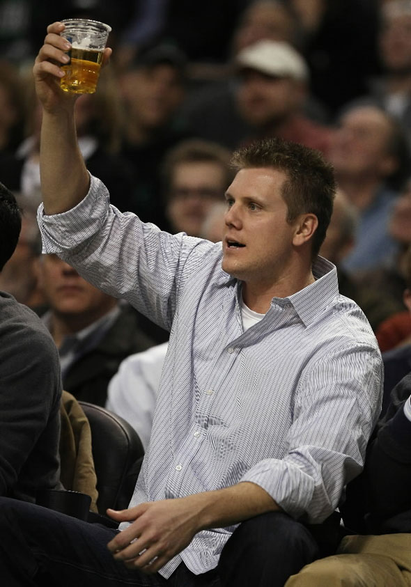 Red Sox pitcher Jonathan Papelbon salutes the fans as he watches the Boston Celtics take on the Orlando Magic on January 17, 2011 at the TD Garden