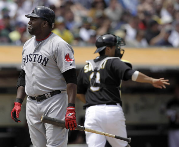 David Ortiz, left, reacts after striking out against the Oakland Athletics to end the top of the fifth inning of a baseball game in Oakland, Calif., Wednesday, July 21, 2010. Athletics' catcher Kurt Suzuki, right, looks on.