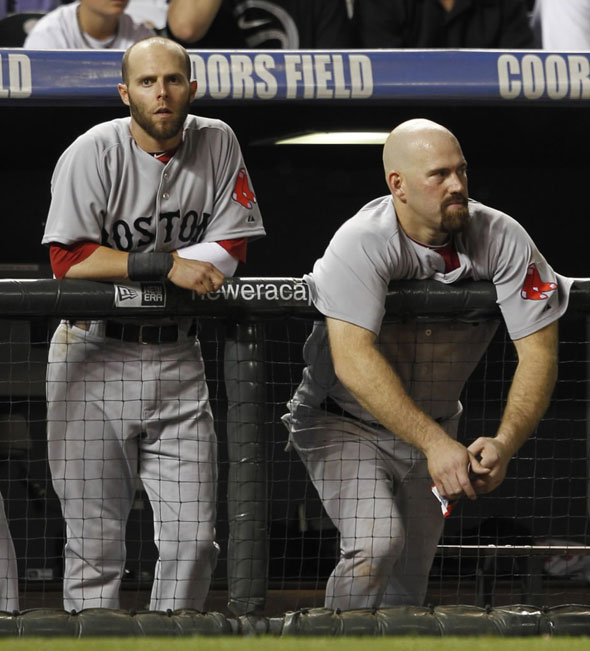 Red Sox second baseman Dustin Pedroia, left, and first baseman Kevin Youkilis look on as pinch-hitter Mike Lowell grounds out against the Colorado Rockies to end the ninth inning of the Rockies' 2-1 victory in an interleague baseball game in Denver on Tuesday, June 22, 2010.